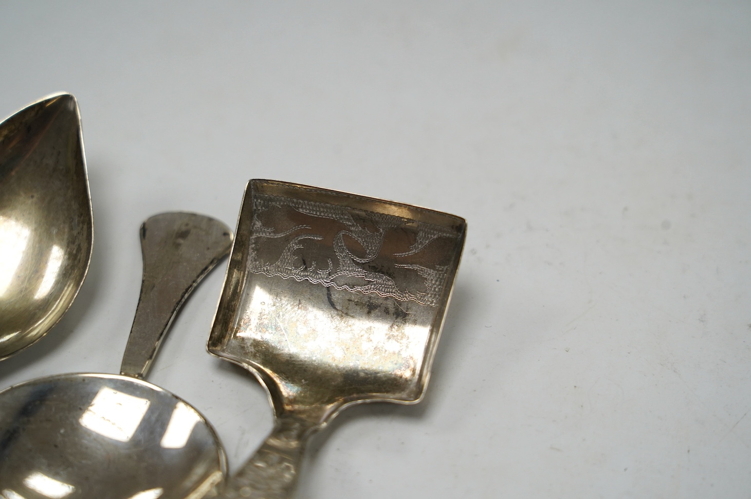 Five assorted silver caddy spoons, including shovel bowl by Cocks & Bettridge, Birmingham, 1810, 61mm, leaf bowl by William Pugh, Birmingham, 1814, Eley & Fearn, London, 1804, bright cut engraved bowl, George Baskerville